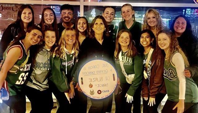 Coach Rapps with her Carroll Dance team at Bucks game