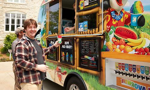 A staff member eating a snow cone